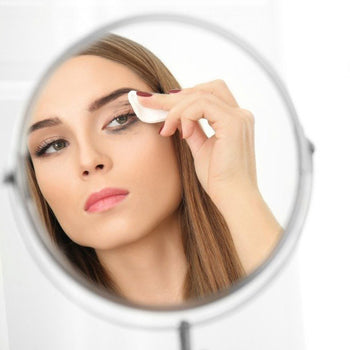 Girl removing eyeliner with a cotton pad